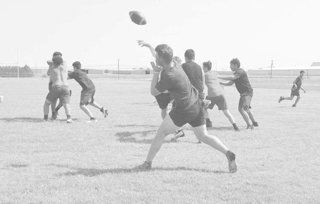 DEEP BALL - Levelland Lobo Rusty Johnson launches a deep ball to his receiver. Pictured above is Rusty Johnson behind his O-Line during summer worlouts. (Staff Photo by Aalijah Soliz)