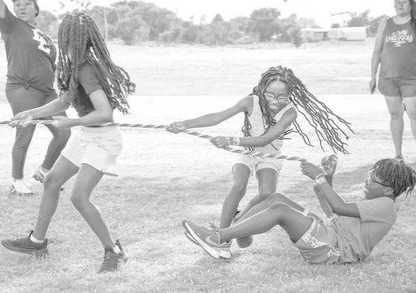 TUG OFWAR - Cadence Minor (LEFT), Camryn Minor (MIDDLE), Za’Kavian Childers (RIGHT) playing games during the Juneteenth celebration. There were many activities including bingo, dominoes, karaoke and a dance. (Staff Photo by Victoria Brynes)